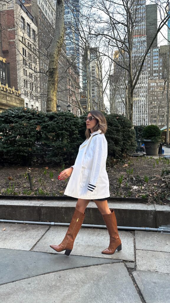 Ivory double-breasted coat with cognac croc-embossed knee-high boots